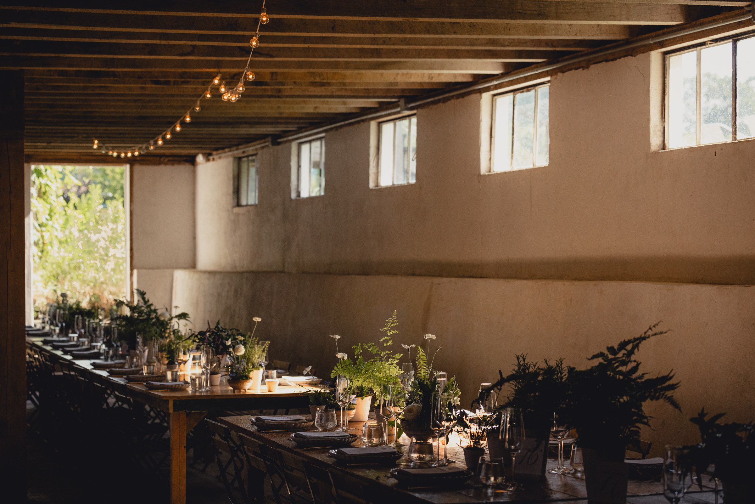 decor styled by Simply Beautiful Events and florals by Pistil and Pollen at wedding reception in barn at The North Farm in Geneva, NY