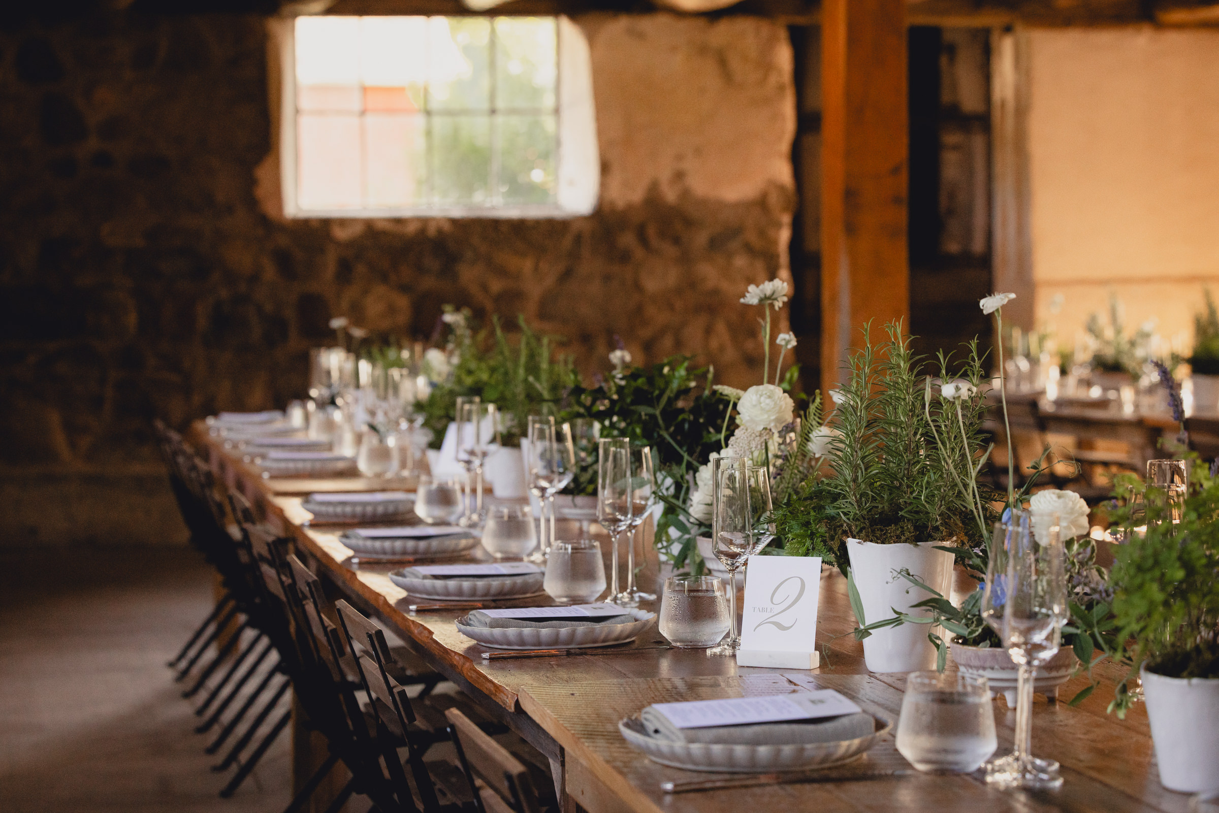 decor styled by Simply Beautiful Events and florals by Pistil and Pollen at wedding reception in barn at The North Farm in Geneva, NY