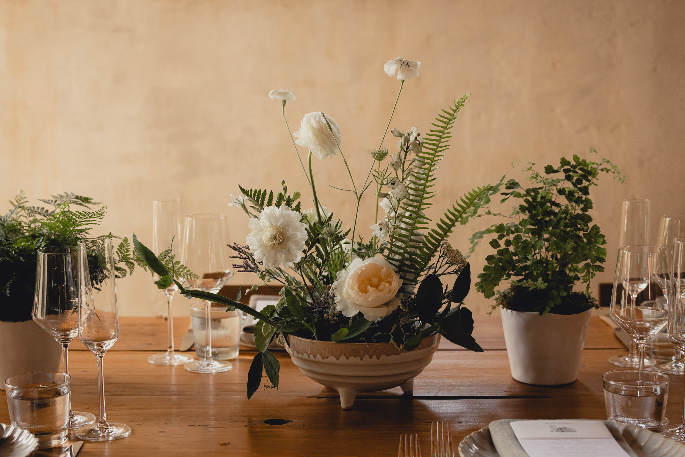 decor styled by Simply Beautiful Events and florals by Pistil and Pollen at wedding reception in barn at The North Farm in Geneva, NY