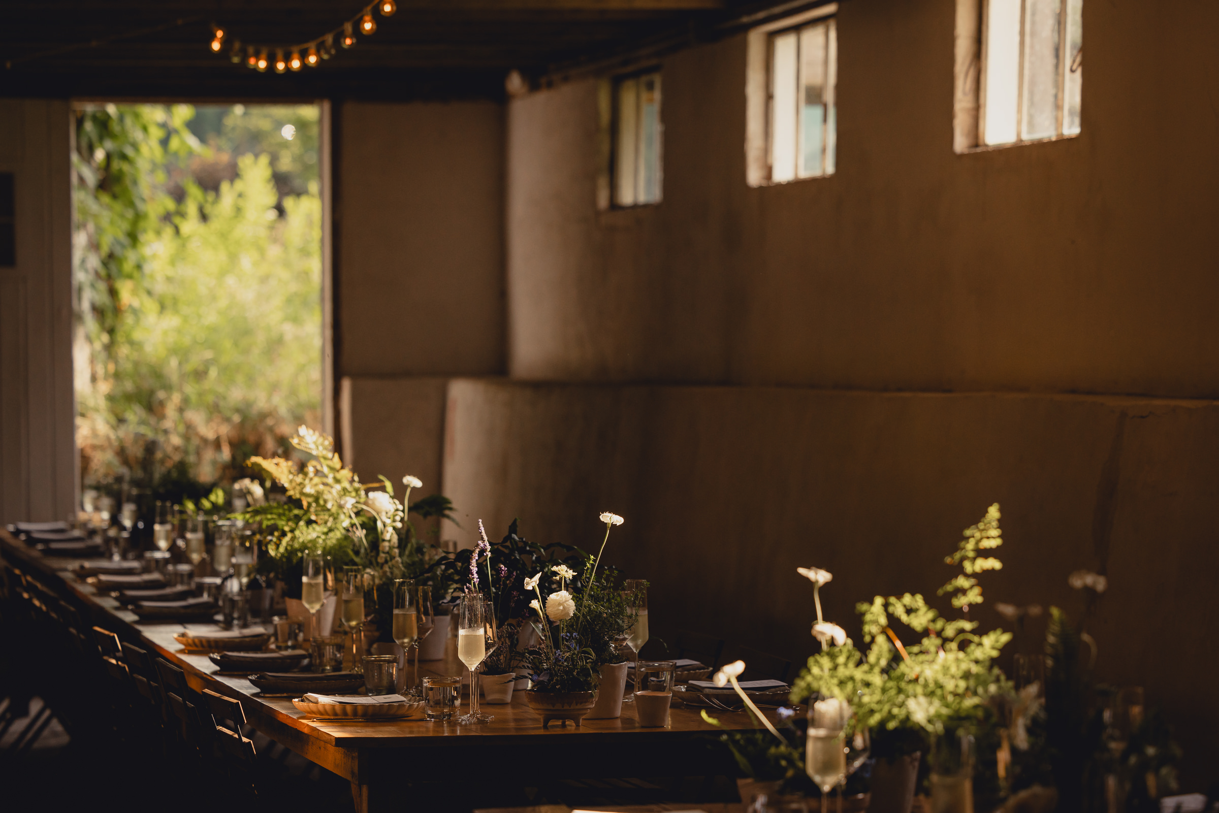 decor styled by Simply Beautiful Events and florals by Pistil and Pollen at wedding reception in barn at The North Farm in Geneva, NY