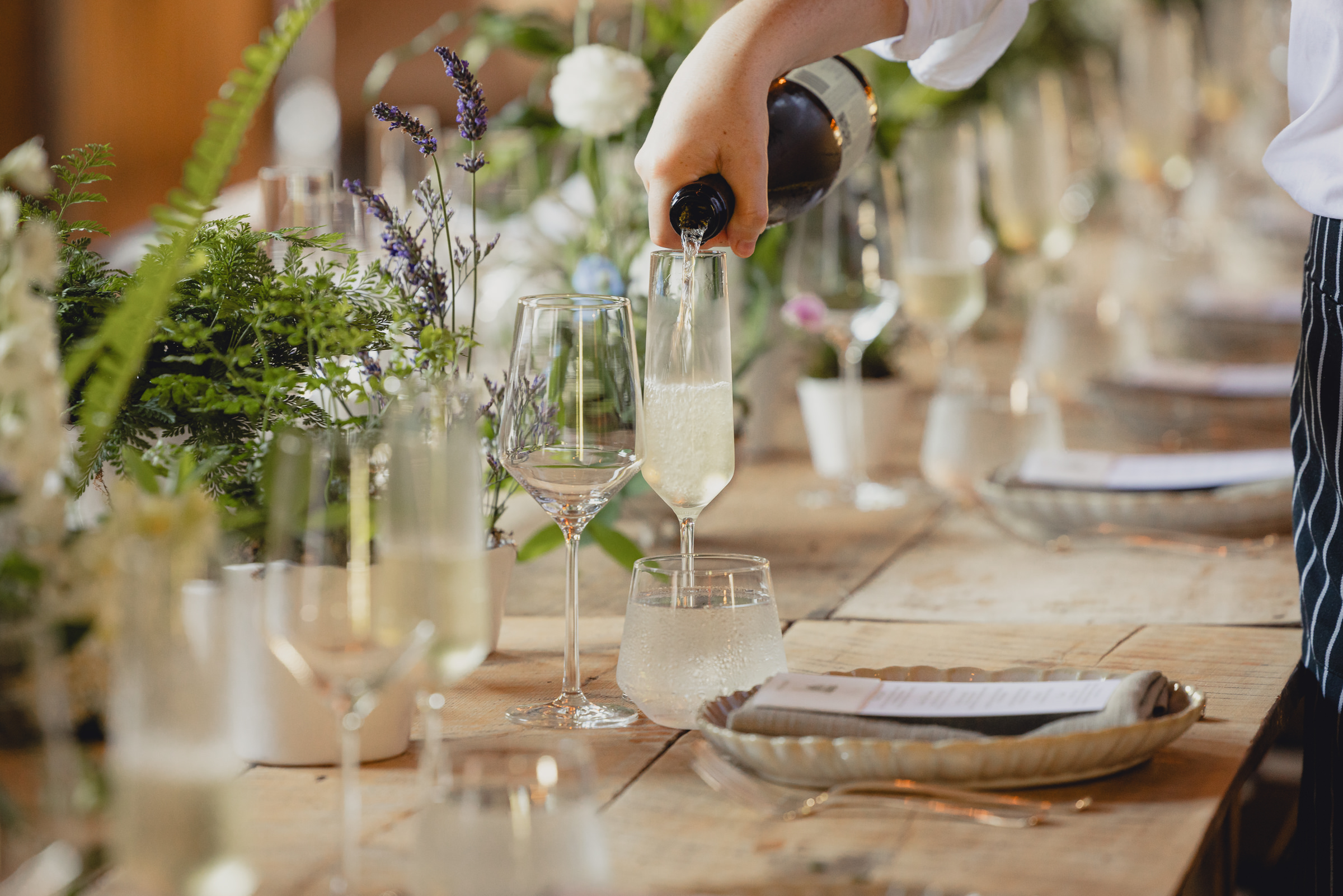 decor styled by Simply Beautiful Events and florals by Pistil and Pollen at wedding reception in barn at The North Farm in Geneva, NY