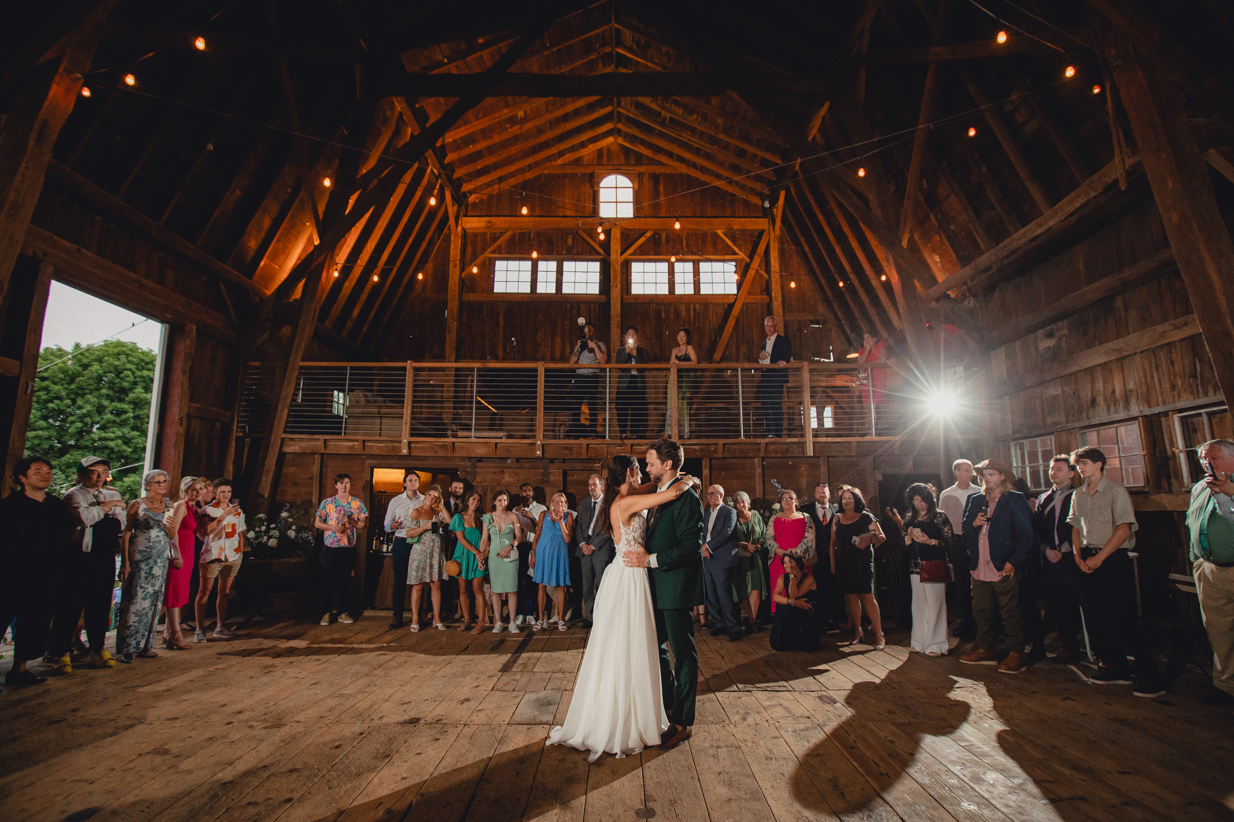 bride and groom dance at wedding reception in barn at The North Farm in Geneva, NY