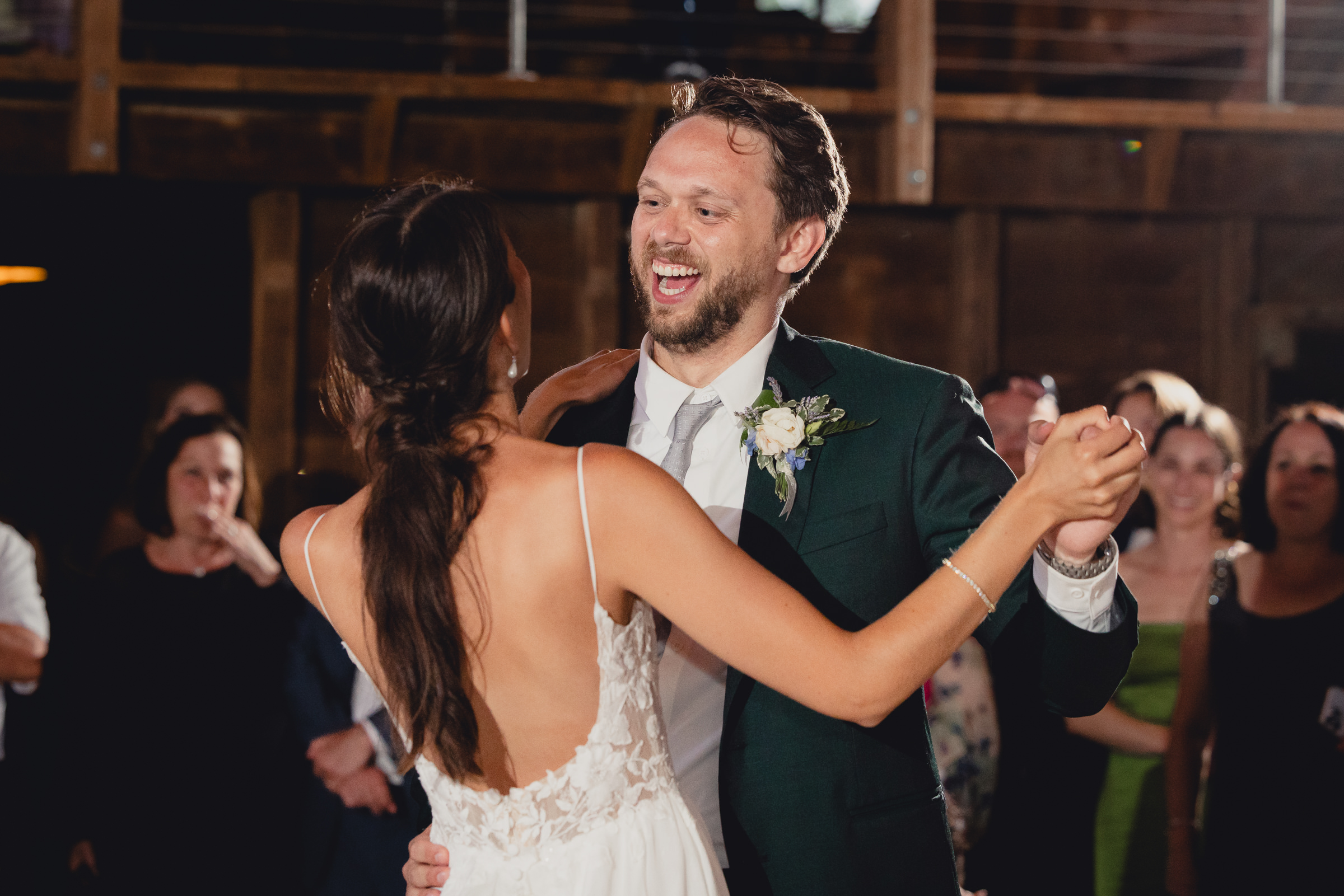 bride and groom dance at wedding reception in barn at The North Farm in Geneva, NY