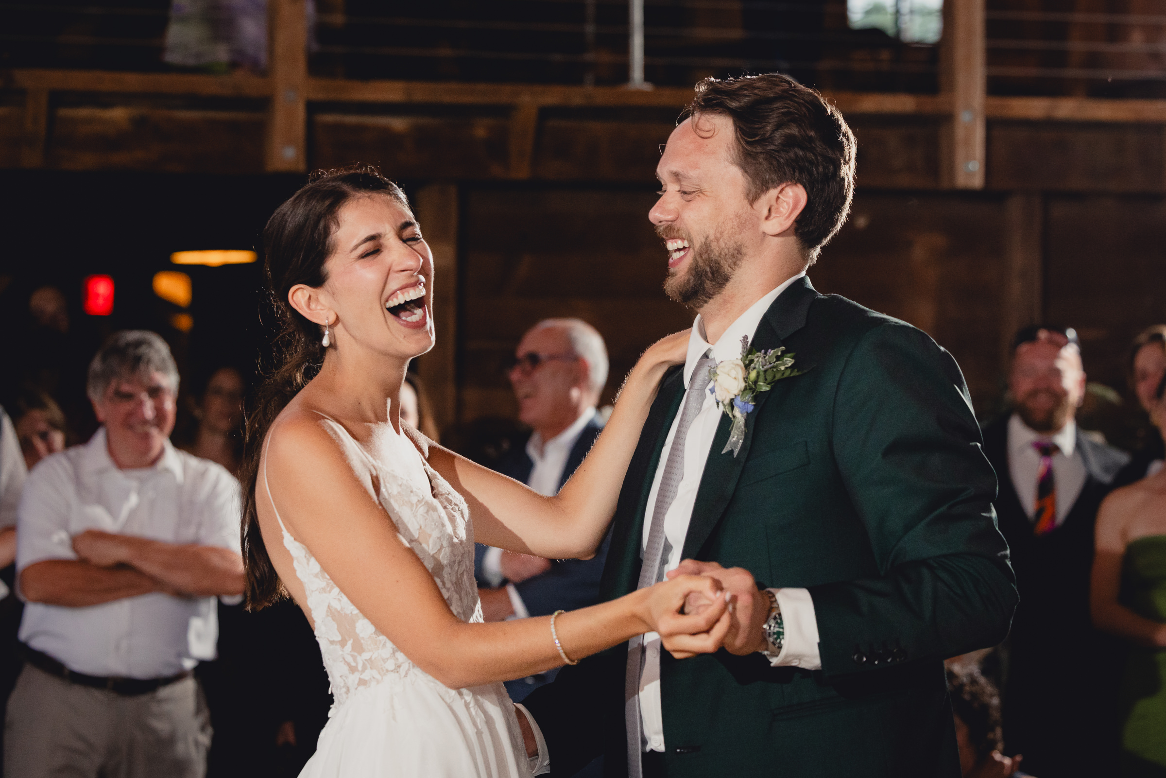 bride and groom dance at wedding reception in barn at The North Farm in Geneva, NY