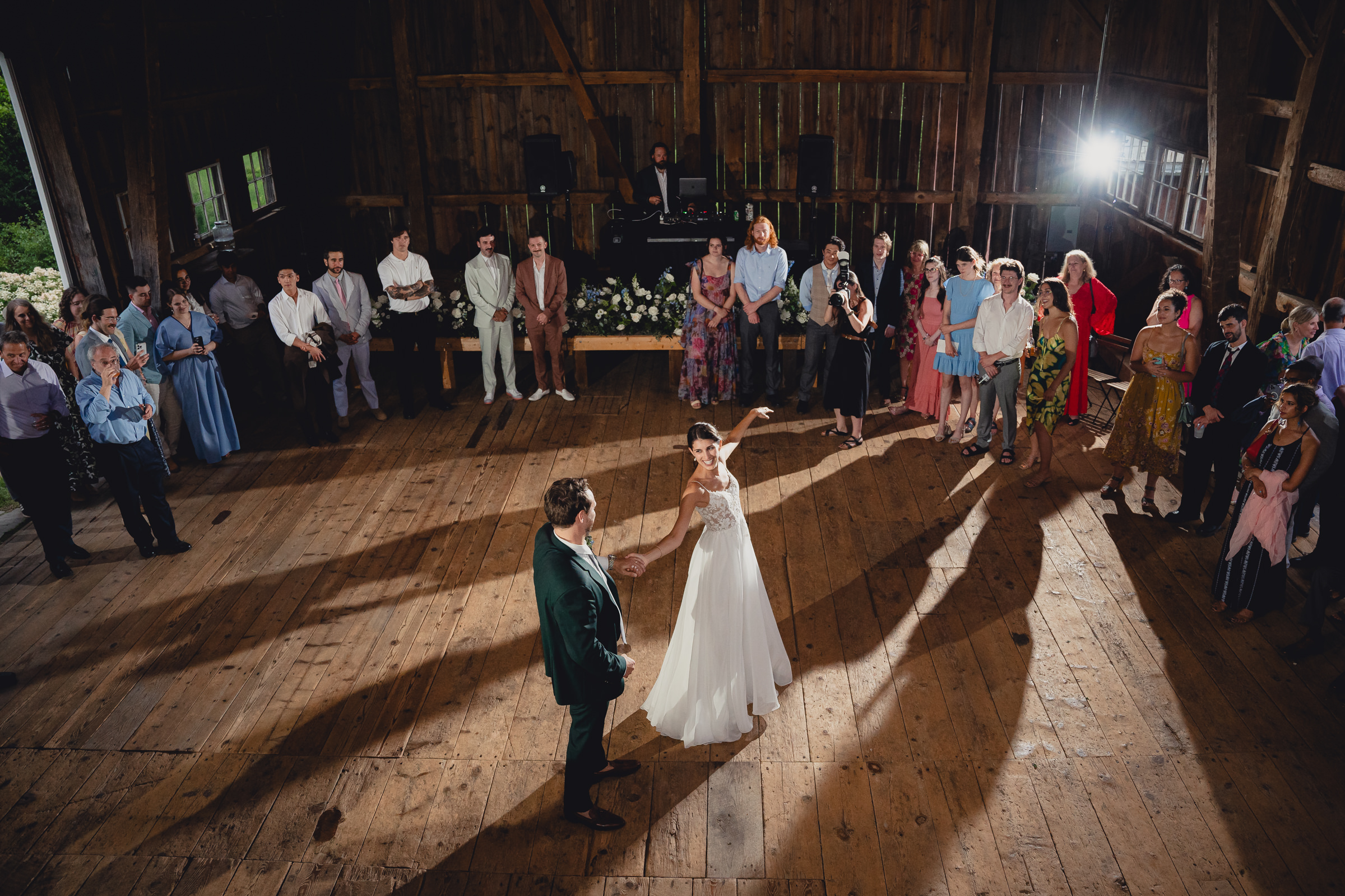 bride and groom dance at wedding reception in barn at The North Farm in Geneva, NY