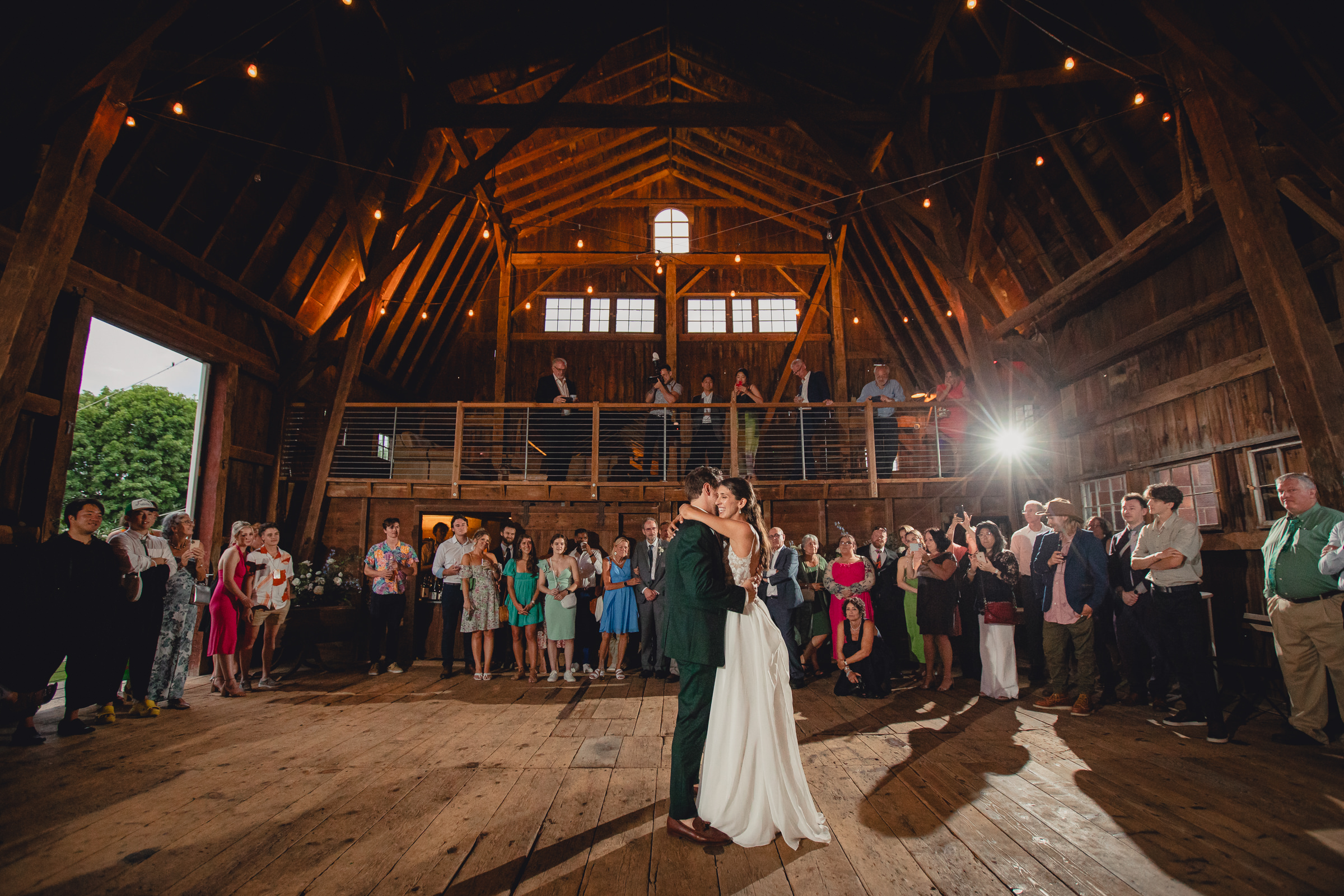 bride and groom dance at wedding reception in barn at The North Farm in Geneva, NY