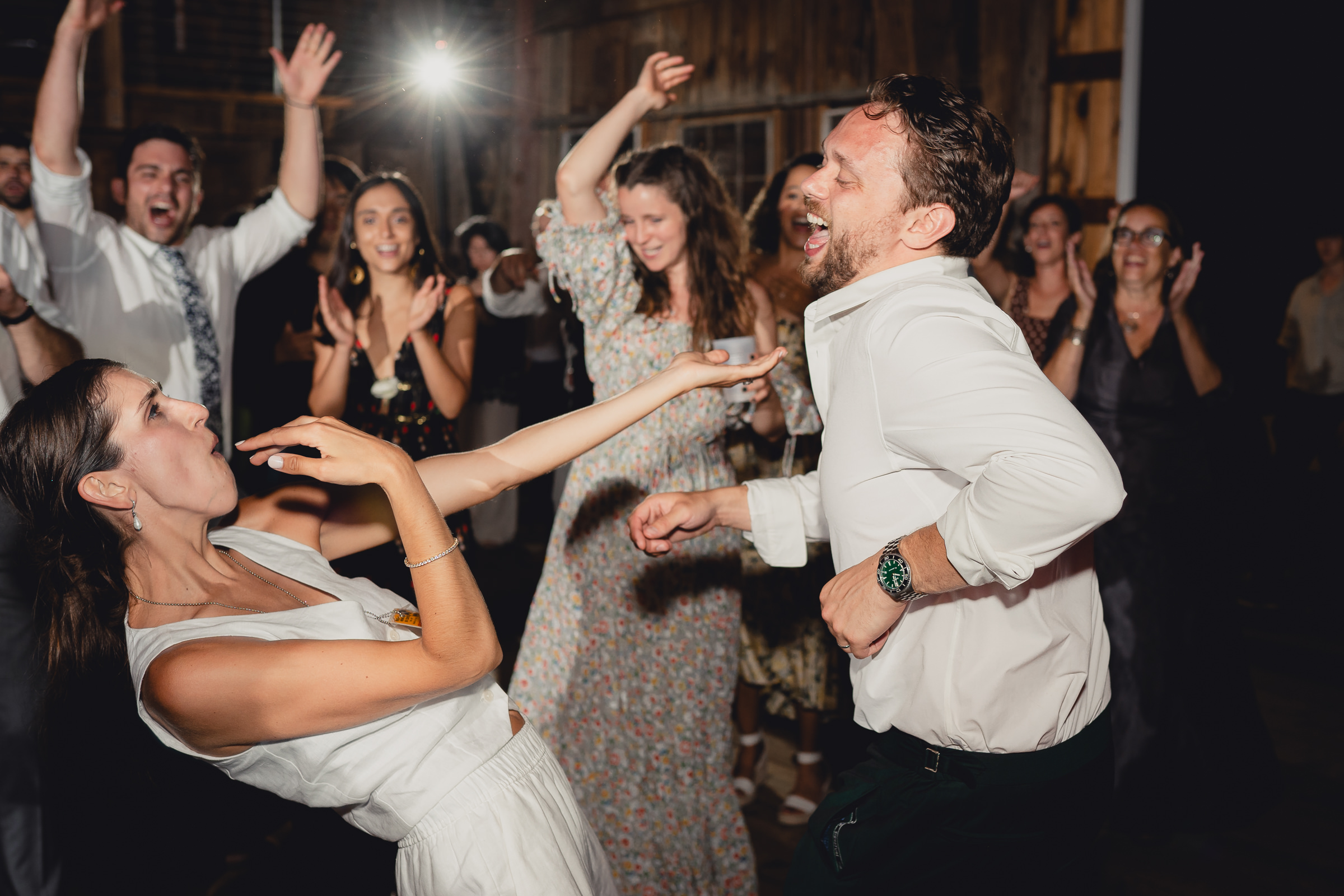 bride and groom dance at wedding reception in barn at The North Farm in Geneva, NY