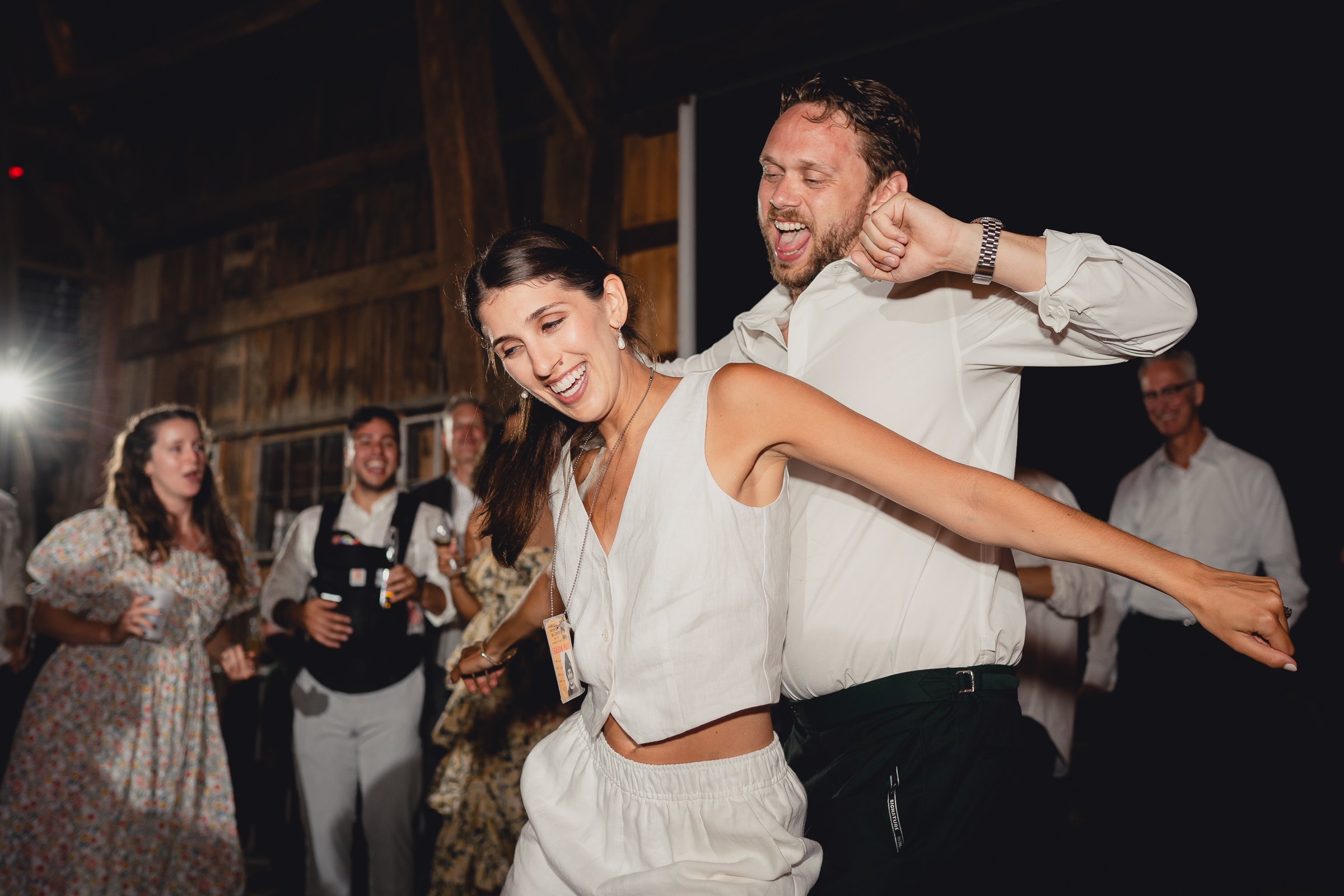 bride and groom dance at wedding reception in barn at The North Farm in Geneva, NY