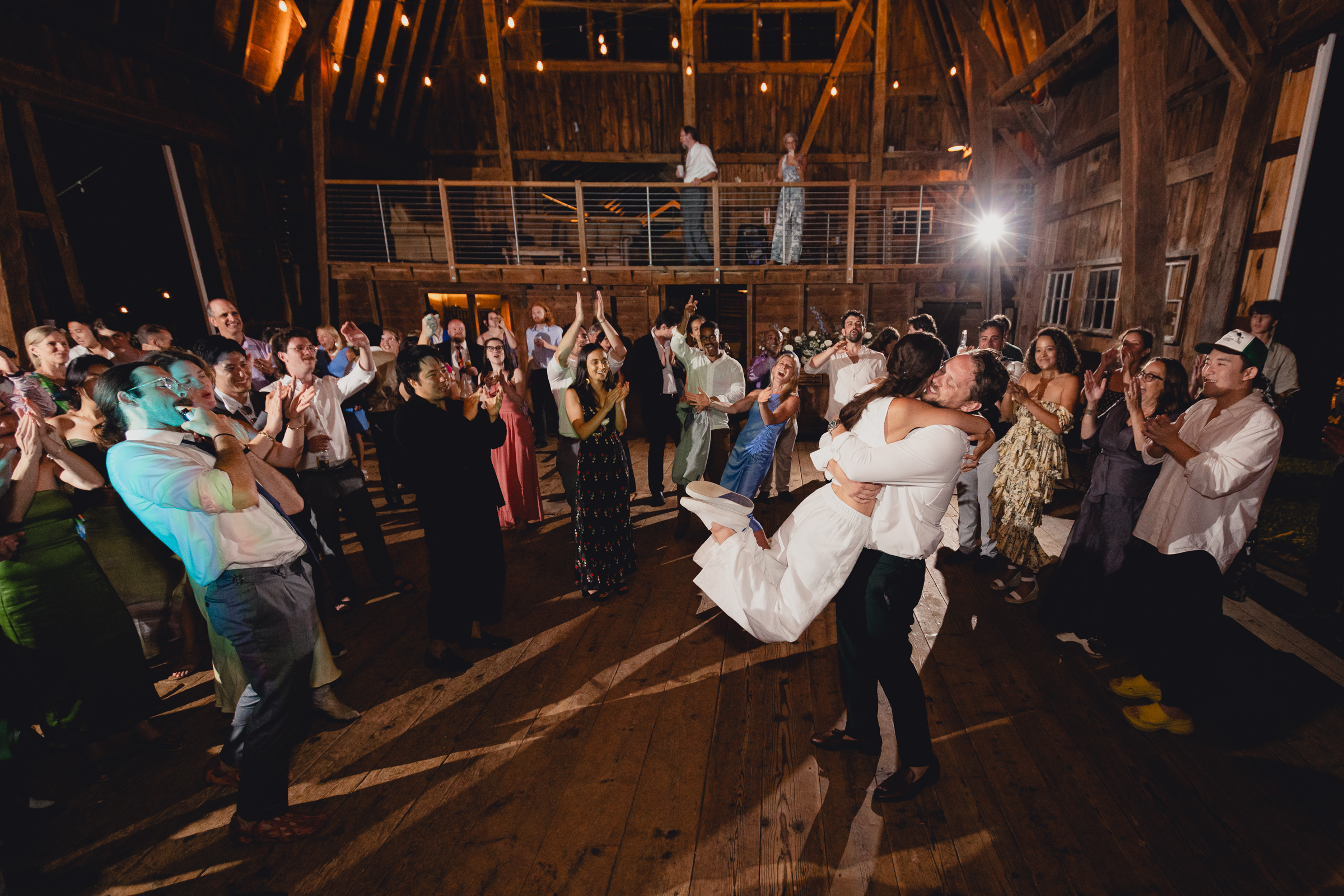 bride and groom dance at wedding reception in barn at The North Farm in Geneva, NY