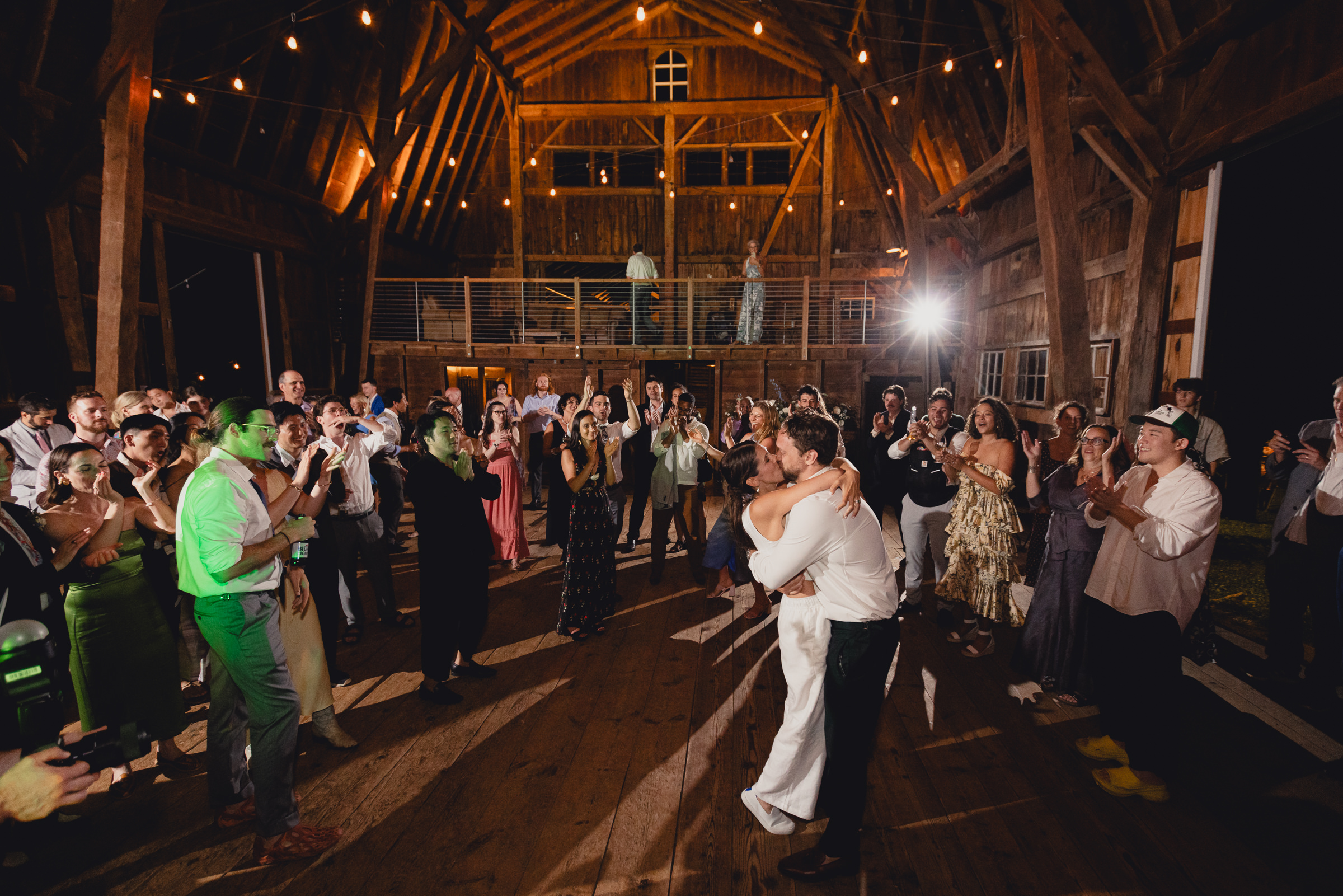 bride and groom dance at wedding reception in barn at The North Farm in Geneva, NY