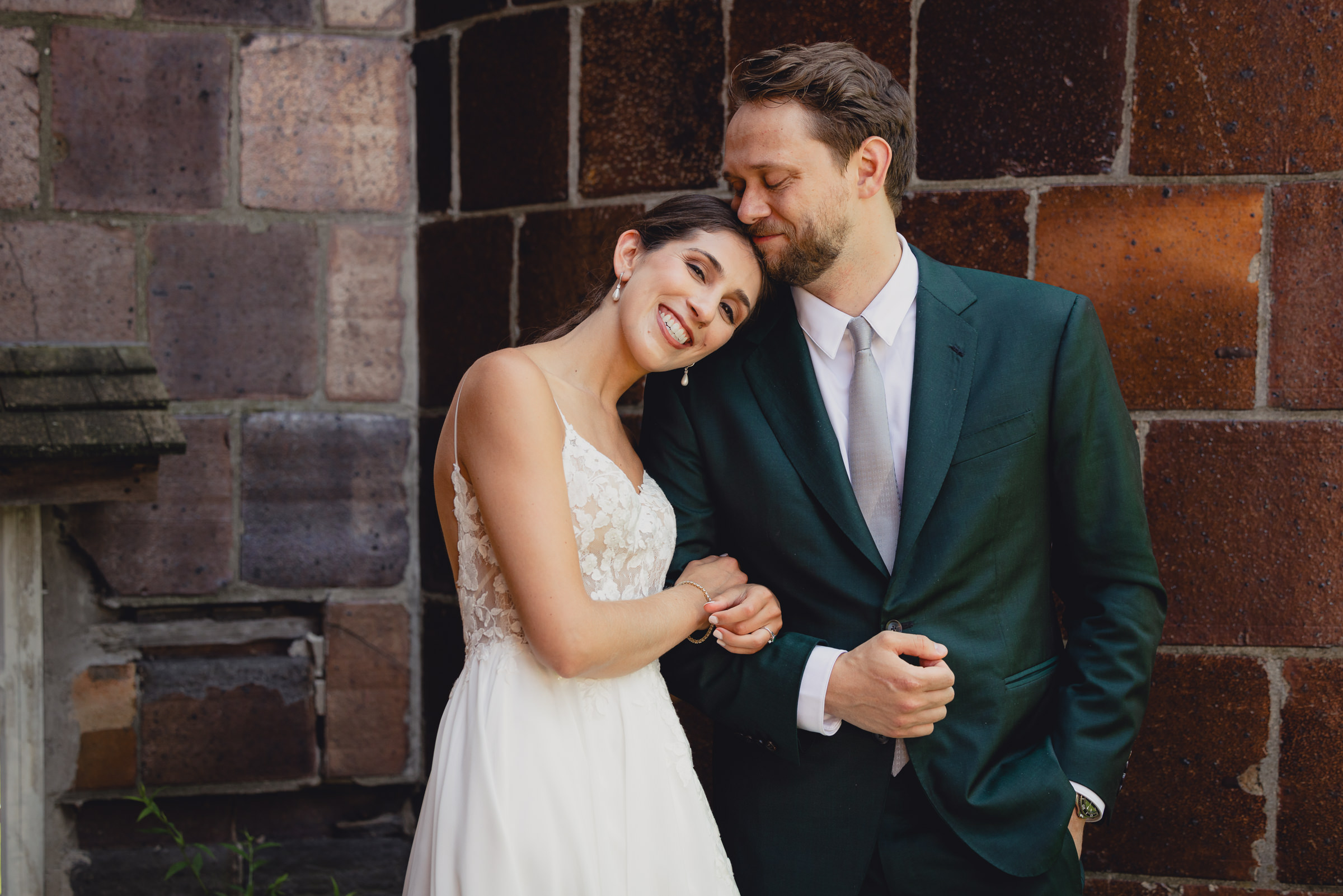 Bride and groom pose for portraits in front of The North Farm barns at a wedding in Geneva, NY