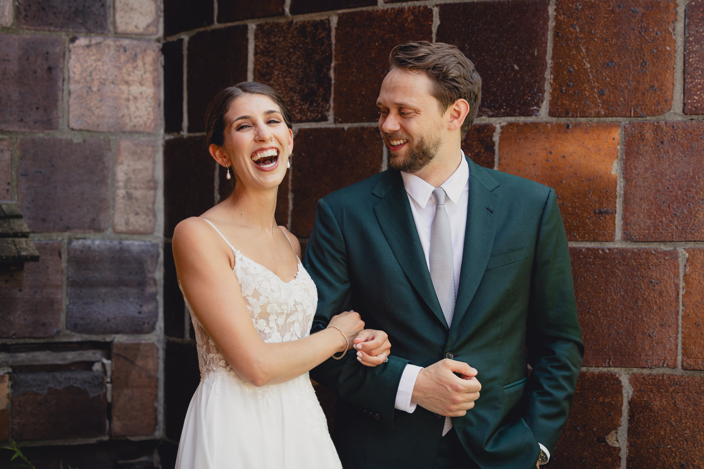 Bride and groom pose for portraits in front of The North Farm barns at a wedding in Geneva, NY