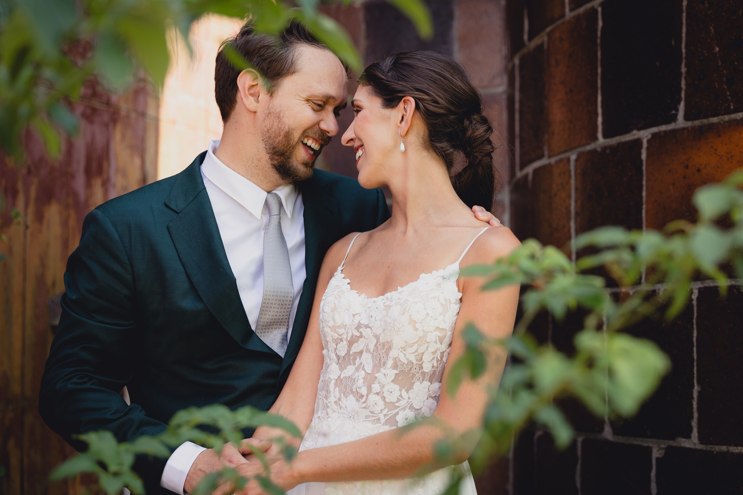 Bride and groom pose for portraits in front of The North Farm barns at a wedding in Geneva, NY