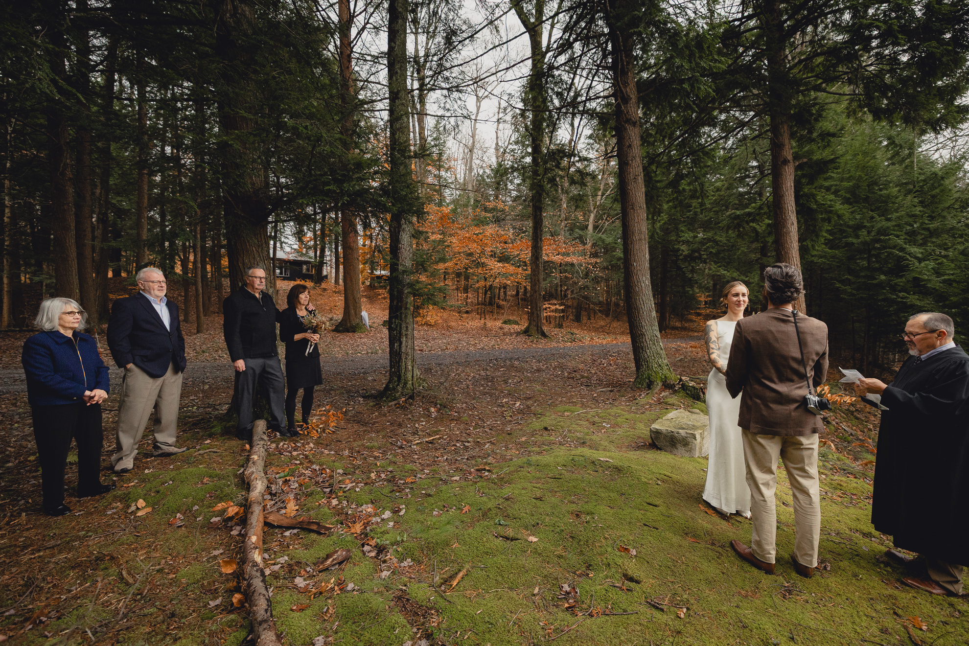 family looks on as bride and groom say vows during micro wedding elopement ceremony at Vanderkamp NY in the Adirondacks
