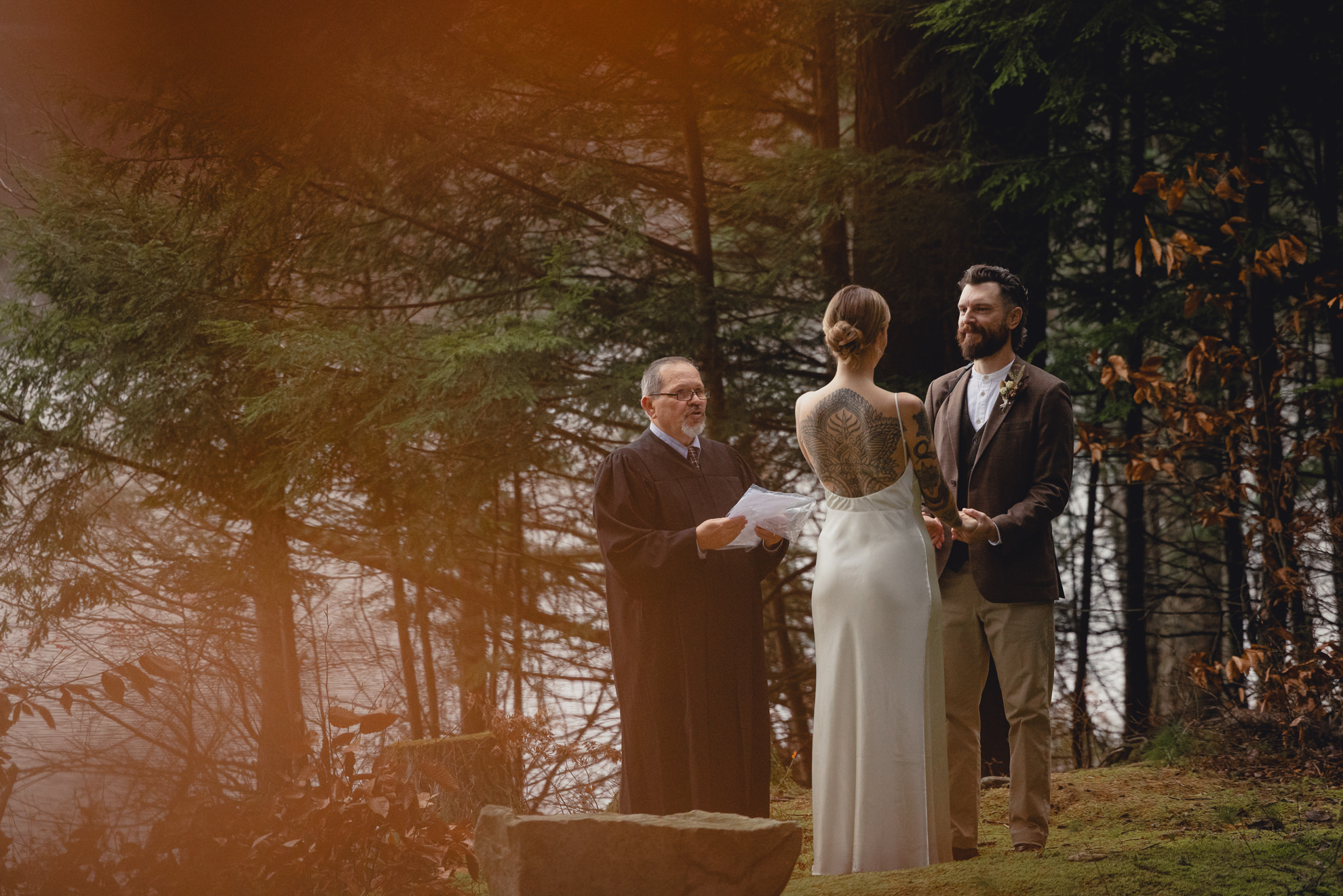 groom looks at bride during micro wedding elopement ceremony at Vanderkamp NY in the Adirondacks